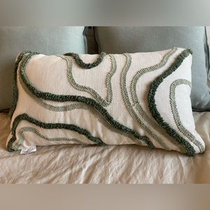 Cream, green detailed pillow